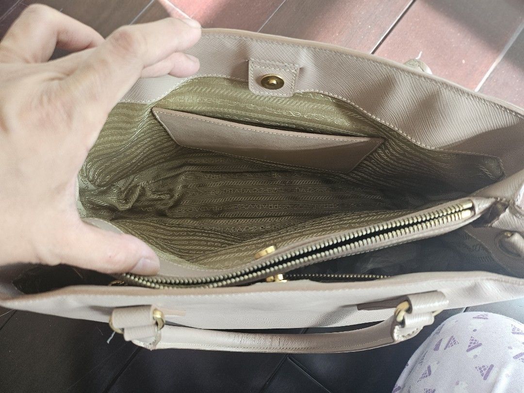 Authentic Pre-Loved Prada Saffiano Tote Bag (Category: Luxury Bags & Wallets) located in Taguig. Submitted by shoptiludrop888 (Listing ID 1296908745, Image 3). Description: Prada Saffiano Lux Leather Tote Top Handle Shoulder Bag - authentic - preloved condition. AS IS WHERE IS. Kindly manage expectations as this is preloved condition. - can be worn as hand bag, shoulder bag or cross body bag with the shoulder straps. - everything in great conditi