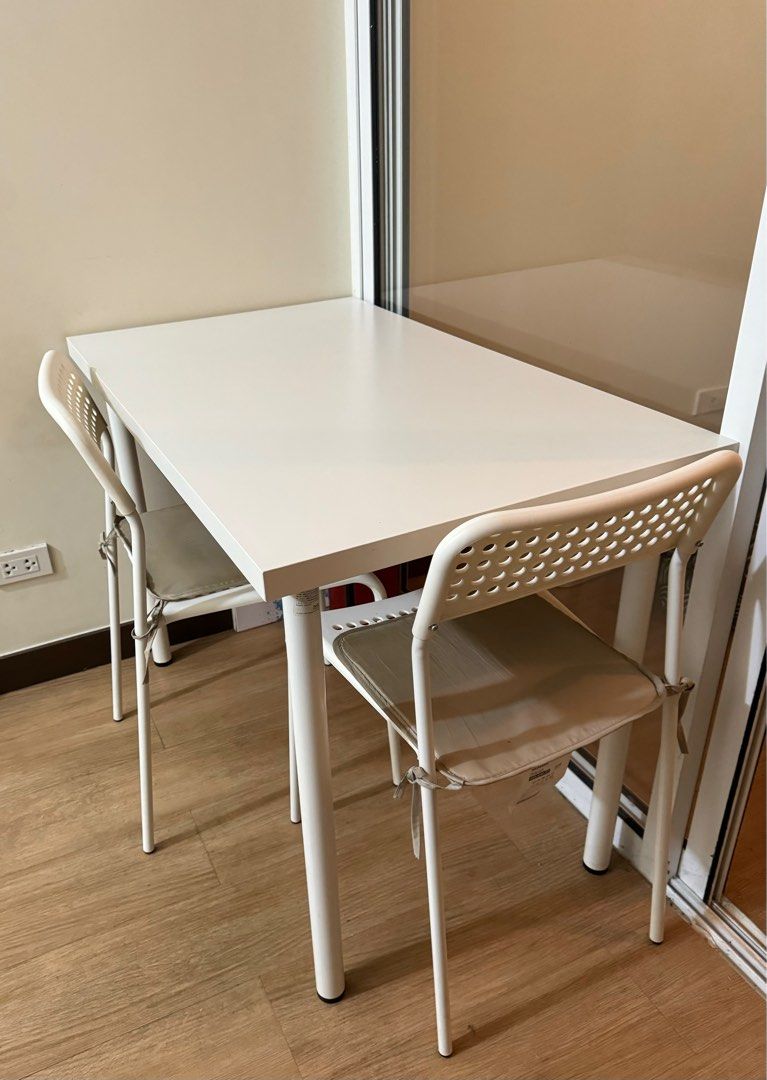 Ikea white table and chairs (Category: Tables & Sets) located in Pasig City. Submitted by joyshares (Listing ID 1297187068, Image 3). Description: White table from ikea still soooo white coz i’ve always used a transparent table cover 2 chairs from ikea as well Rfs: moving out.