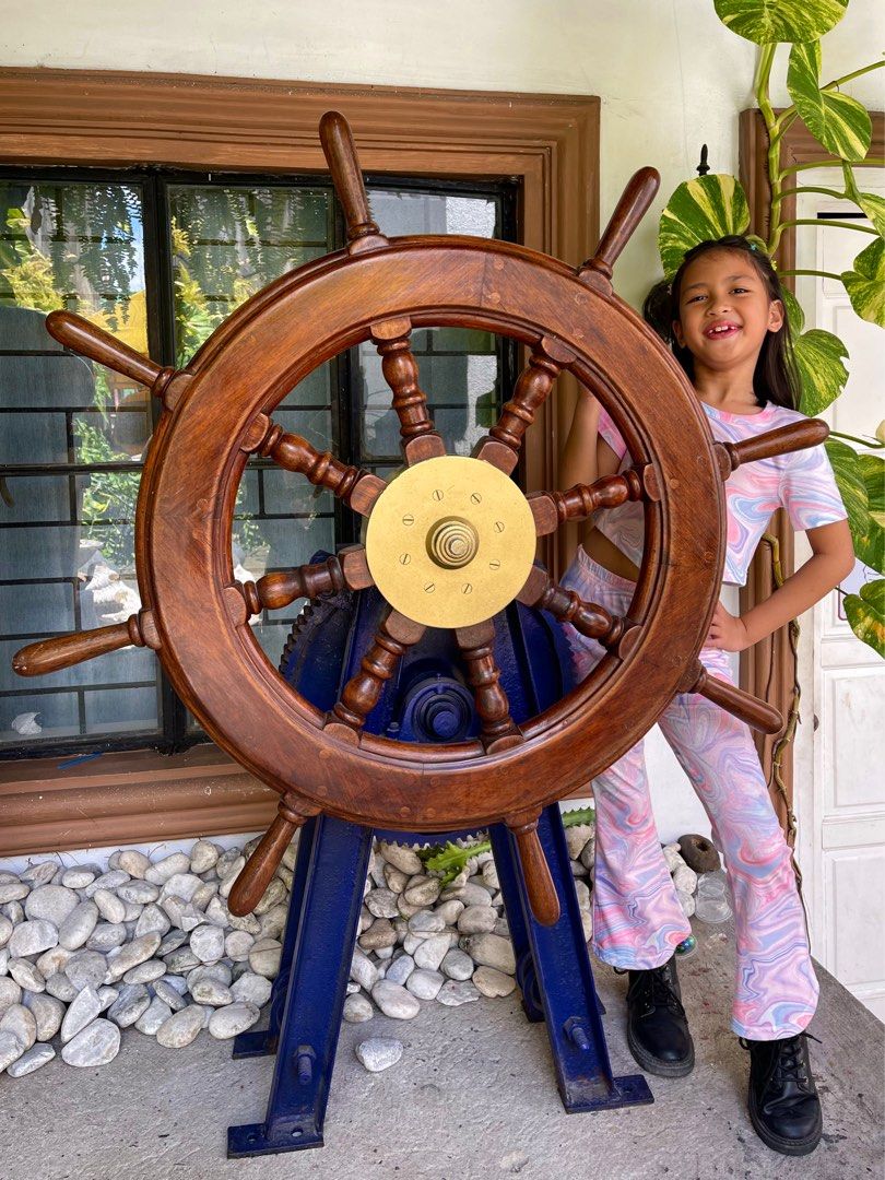 Solid wood and brass ship helm / steering wheel (Category: Vintage Collectibles) located in Marikina City. Submitted by sam_illano (Listing ID 1297214230, Image 1). Description: Solid wood and brass ship helm complete w pedestal and gears in very good condition. A perfect man cave piece. Dimensions: 42” length 55” height 17” width Price is P48,500 + minimal delivery fee. Can ship via lalamove or AP cargo. Marikina area, thank you. .