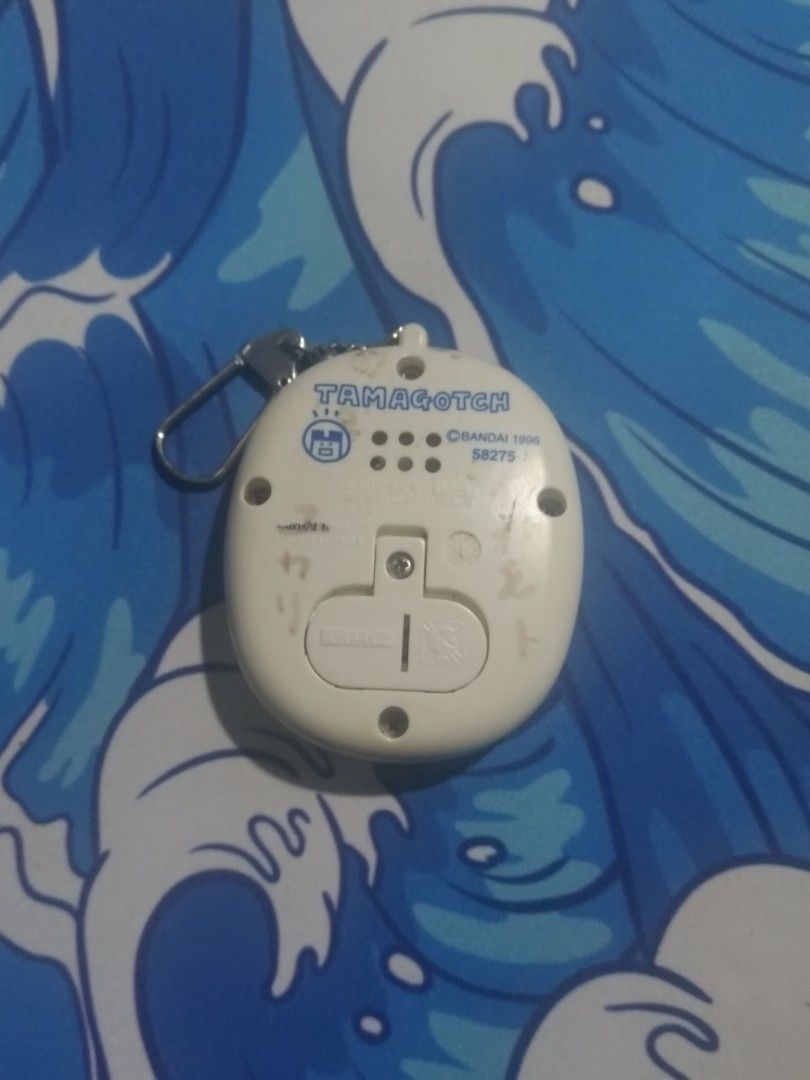 Tamagotchi Mame game white with characters (Category: Interactive Toys) located in Taguig. Submitted by Artxious (Listing ID 1297166968, Image 2). Description: This is an extra tamagotchi mame I have. It's like a tetris game where you watch characters that looks the same. It works perfectly fine too. Shipping will be thru Flashexpress, Jnt, Grab, Lalamove, Angkas, Joyride.