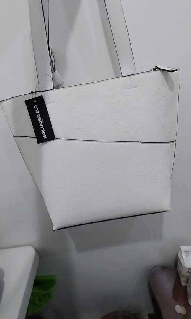 Karl Lagerfeld (Category: Shoulder Bags) located in Quezon City. Submitted by dveee (Listing ID 1297427778, Image 2). Description: Karl Lagerfeld White shoulder bag with 3 compartments 2 buttons and middle zipper as seen in picture original price 198 usd from retail plus taxes price is already fixed.