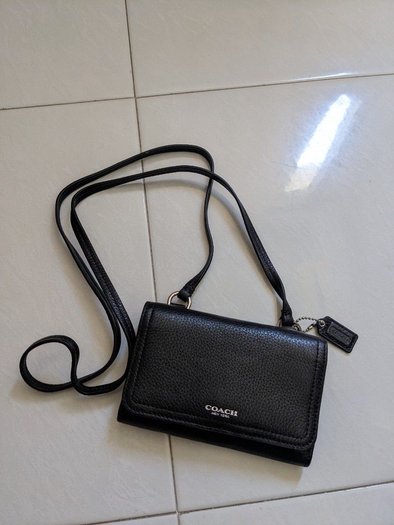Coach sling pouch (Category: Bags & Wallets) located in Singapore. Submitted by 1ydth (Listing ID 1300981515, Image 1). Description: given as a gift. never used, padding inside still intact. kept in storage for some time. Small crossbody for keeping just the essentials (wallet sized items) collection at Hougang MRT.