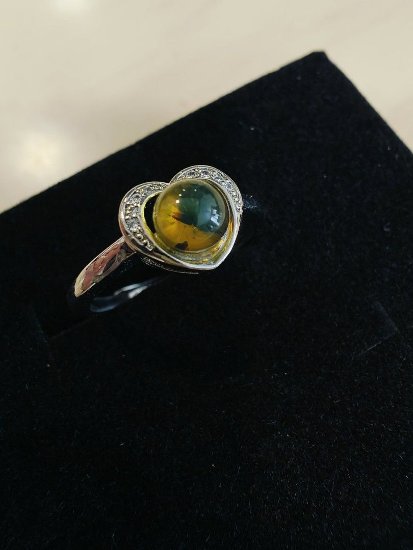 Amber ring (Category: Rings) located in Singapore. Submitted by kittynara (Listing ID 1302575199, Image 2). Description: Natural amber stone ring Authentic stones are more likely to have minor imperfections, like an uneven shape, dips in the surface, or pitting and some inclusions . not for fussy and difficult buyers ! with 925 adjustable ring size suitable as a mother's Day gift girlfriend or friendship gift come with a gift box able to send by 