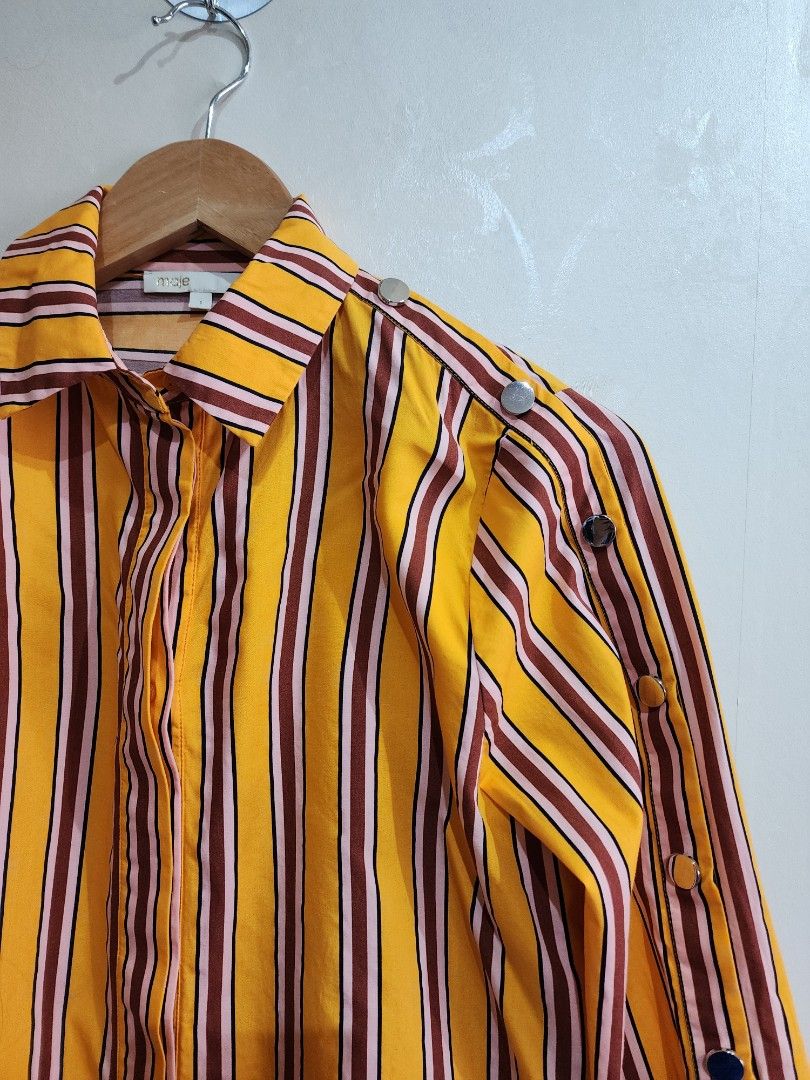 MAJE Orange Striped Long Sleeve (Category: Luxury Apparel) located in Quezon City. Submitted by chrizcboutique (Listing ID 1302942967, Image 3). Description: MAJE Striped Orange with burgundy size 1 can fit small to medium built with multiple stud in sleeve Measurements done in flat shoulder to shoulder approx 14 inches armpit to armpit approx 18 inches length approx 24.5 inches condition still in prestine condition 10/10..like NEW no flaws, no p