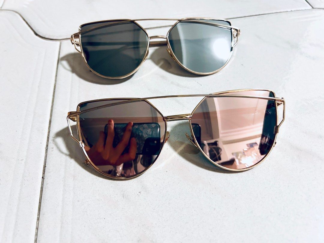 Cat eye sunglasses (Category: Sunglasses & Eyewear) located in Singapore. Submitted by callmefl (Listing ID 1303320708, Image 1). Description: Light blue and light pink, reflective Each for $10 .