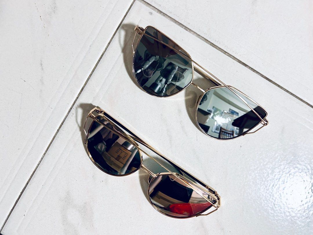 Cat eye sunglasses (Category: Sunglasses & Eyewear) located in Singapore. Submitted by callmefl (Listing ID 1303320708, Image 2). Description: Light blue and light pink, reflective Each for $10 .