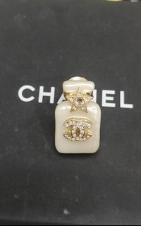 Original Chanel

Pearl White Resin, Crystal CC and Star and Gold Metal Perfume Bottle Brooch