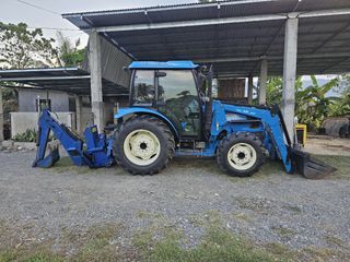 Farm tractor 60hp with aircon, radio, front loader, backhoe, and grass cutter.