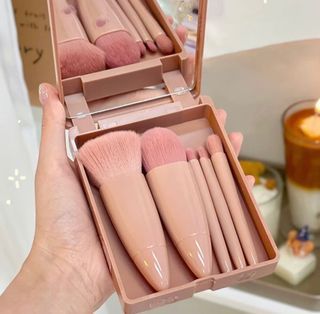 Makeup brushes with compact mirror