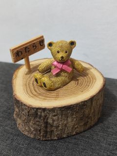 ceramic bear on a log display