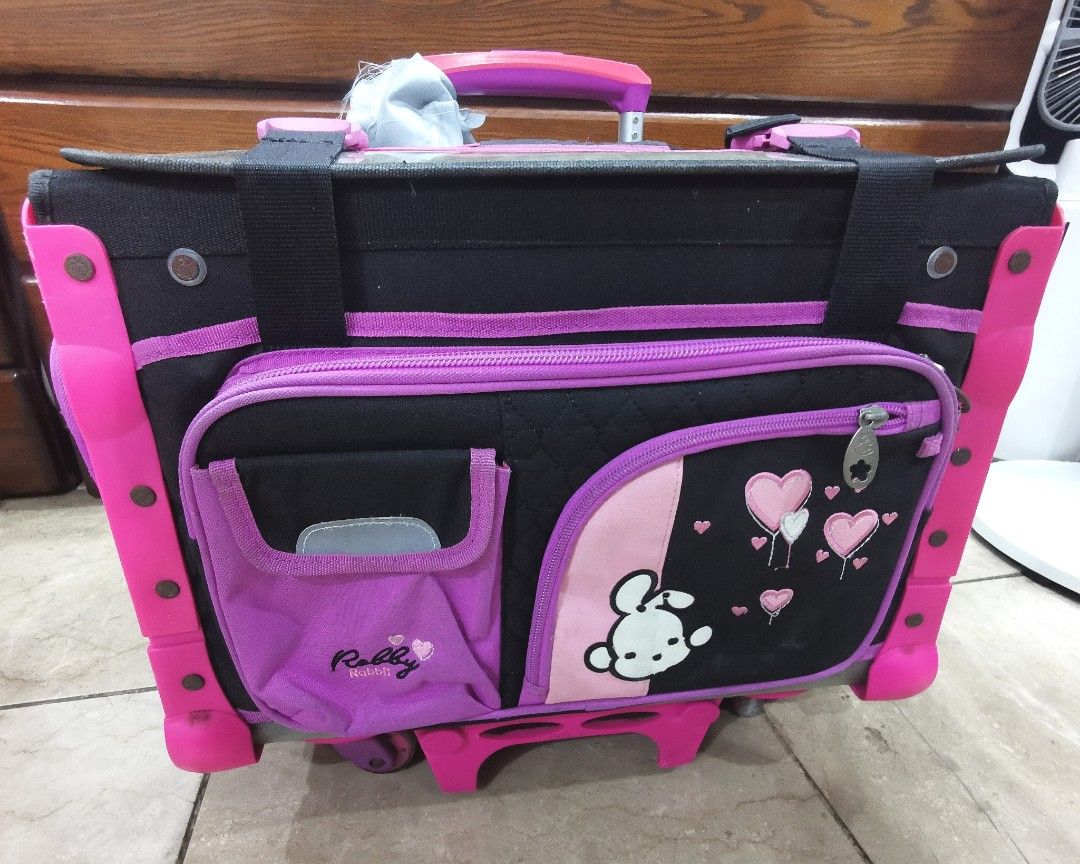 Robby Rabbit Pink, Purple, Black Stroller Bag (Category: Strollers) located in Bacoor. Submitted by ctrl_thrift_ (Listing ID 1304547219, Image 1). Description: Pre-loved Kids Stroller for Girls Color: Black, pink, and purple mix Location: BR1 Details: Includes lunch bag, side bag pocket, rain cover, water bottle, juicer holder Trolley handle with push-button Bottom pull-out front support for better balance & heavy loads Wheels tilt back for extra