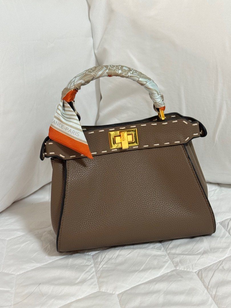 Taupe Fe ndi Peekaboo (Category: Luxury Bags & Wallets) located in Quezon City. Submitted by MissusB (Listing ID 1304525661, Image 1). Description: Already selling Low. Too small for me. not og . Good leather. Good markings. 23cm base, 18cm height.