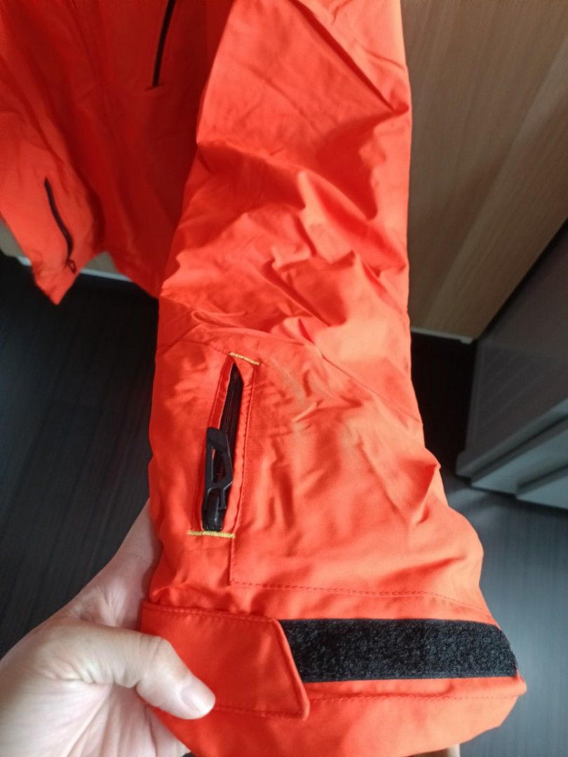 Winter Jacket (Category: Coats, Jackets and Outerwear) located in Singapore. Submitted by liwenchen84 (Listing ID 1304663289, Image 3). Description: Bright orange ski jacket with black lining comes with lots of pockets and straps for adjustments.