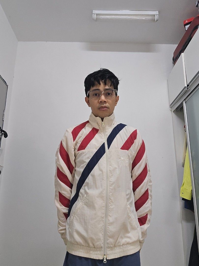 Training Jacket (Category: Activewear) located in Cyberjaya. Submitted by wizardio (Listing ID 1305164357, Image 3). Description: off white color with stripes red and navy.