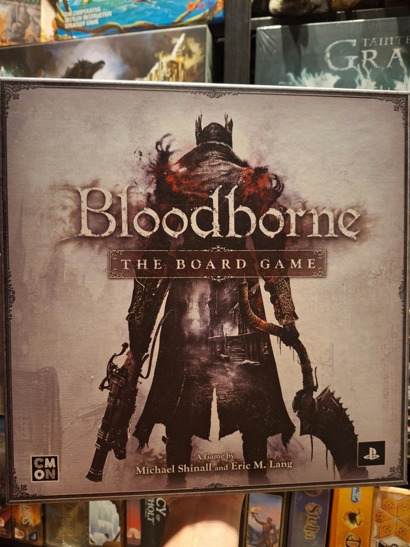 A Collection Of Bloodborne Board Games, Five Boxes - A Core Game And Several Expansions On A Shelf Image553203512