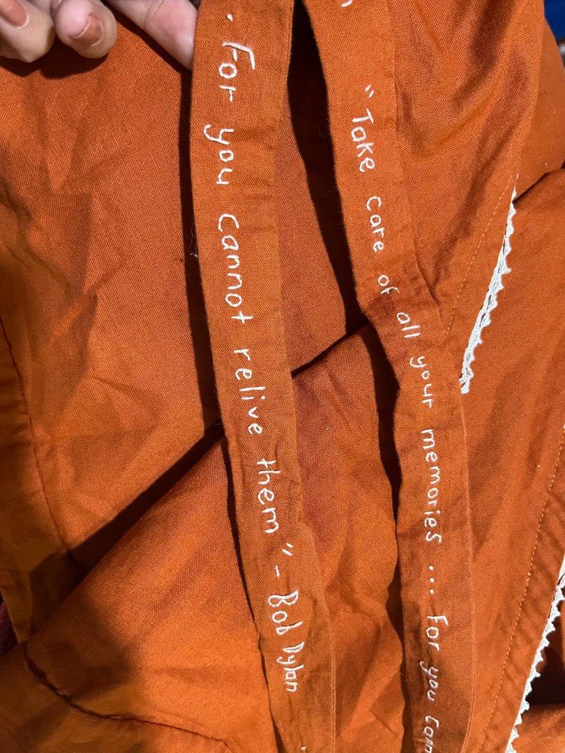 Bob Dylan Embroidered Wrap Bell Sleeved Top (Category: Blouses) located in Mandaluyong City. Submitted by hopeworldplane (Listing ID 1305551494, Image 2). Description: Super nice bell sleeved orange wrap top with Bob Dylan lyrics embroidered on the tie part. fits S-L RFS: too big for me :( .