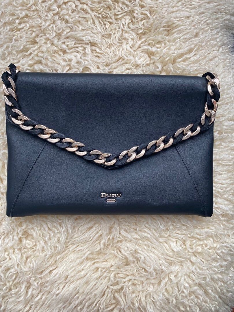 Dune Envelope Bag (Category: Luxury Bags & Wallets) located in Mandaluyong City. Submitted by loved_curated (Listing ID 1305508576, Image 1). Description: Authentic and easy to match Dune envelope bag in black. Selling low because it has a minor chain issue that can be hand sewn in no time. .