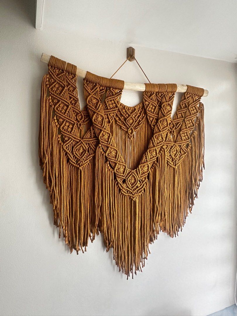 Macrame Wall Hanging (Category: Wall Decor) located in Quezon City. Submitted by loveworn (Listing ID 1305573298, Image 2). Description: Macrame Wall Hanging - copper brown color 30 inches wide 32 inches from wooden dowel to bottom tip of fringe.