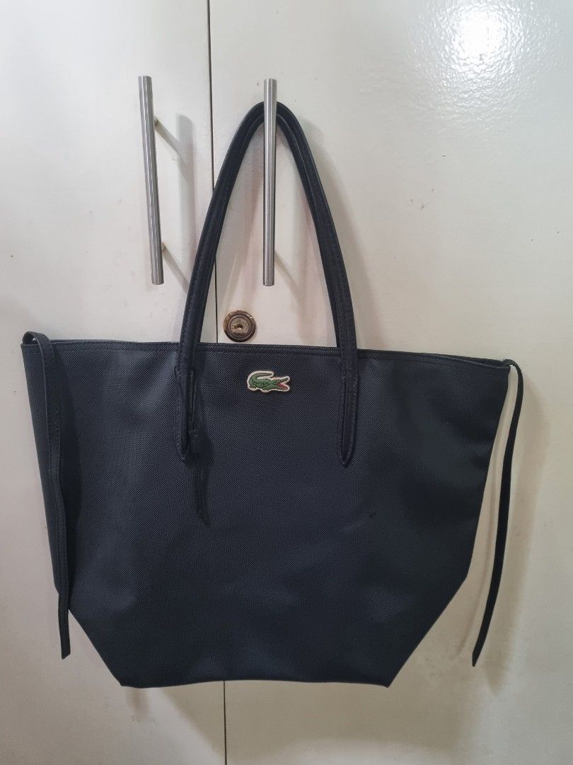Original Lacoste Bag in Black (Category: Tote Bags) located in Manila. Submitted by changingseasons_et.al (Listing ID 1305575733, Image 1). Description: ☘️ Well-loved lacoste bag. ☘️ Purchased at Lacoste store abroad. ☘️ Guaranteed authentic. ☘️ This is pre-loved item with signs of usage. Hence selling low. ☘️ No zipper..
