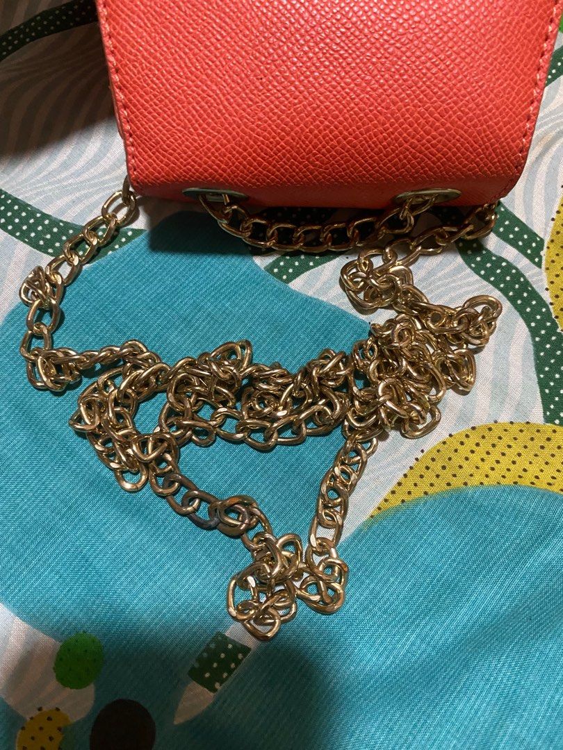 Forever 21 mini sling bag coin purse (Category: Wallets & Card holders) located in Manila. Submitted by nicoleizzy (Listing ID 1305978168, Image 3). Description: - tarnished chains(see pics) - bright orange color.