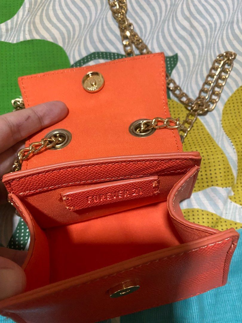 Forever 21 mini sling bag coin purse (Category: Wallets & Card holders) located in Manila. Submitted by nicoleizzy (Listing ID 1305978168, Image 2). Description: - tarnished chains(see pics) - bright orange color.