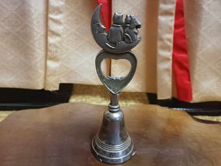 vintage silver bell and bottle opener cat design