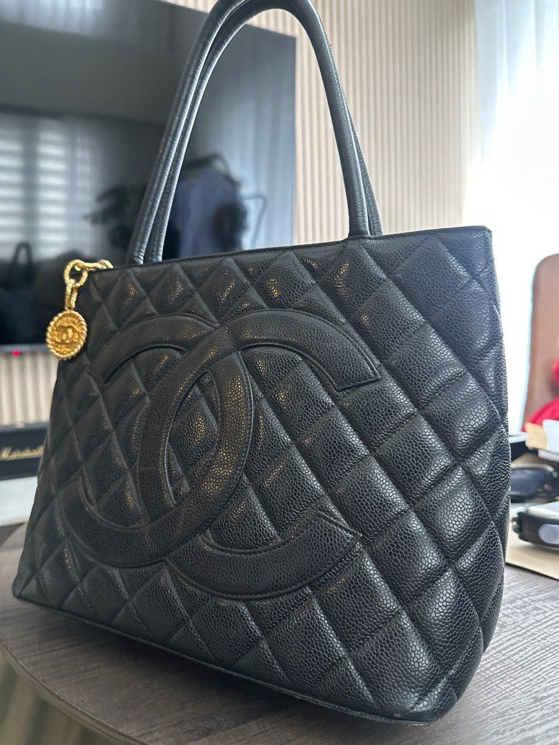 Chanel medallion caviar leather gold hardware (Category: Luxury Bags & Wallets) located in Pasig City. Submitted by ecrz19 (Listing ID 1301861948, Image 1). Description: Chanel Medallion in Black caviar leather with gold hardware Guaranteed authentic or your money back Inclusions: dustbag Stitching, hardwares and zipper are all perfectly fine. No holes on the leather. Flaws: signs of use - some rubs on bottom piping. Hardly noticeable as it is on