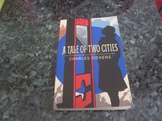 A TALE OF TWO CITIES BY CHARLES DICKENS , PAPERBACK USED BOOK IN VERY GOOD CONDITION .