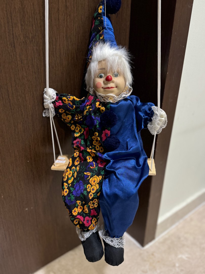 Porcelain clown on swing hotsell