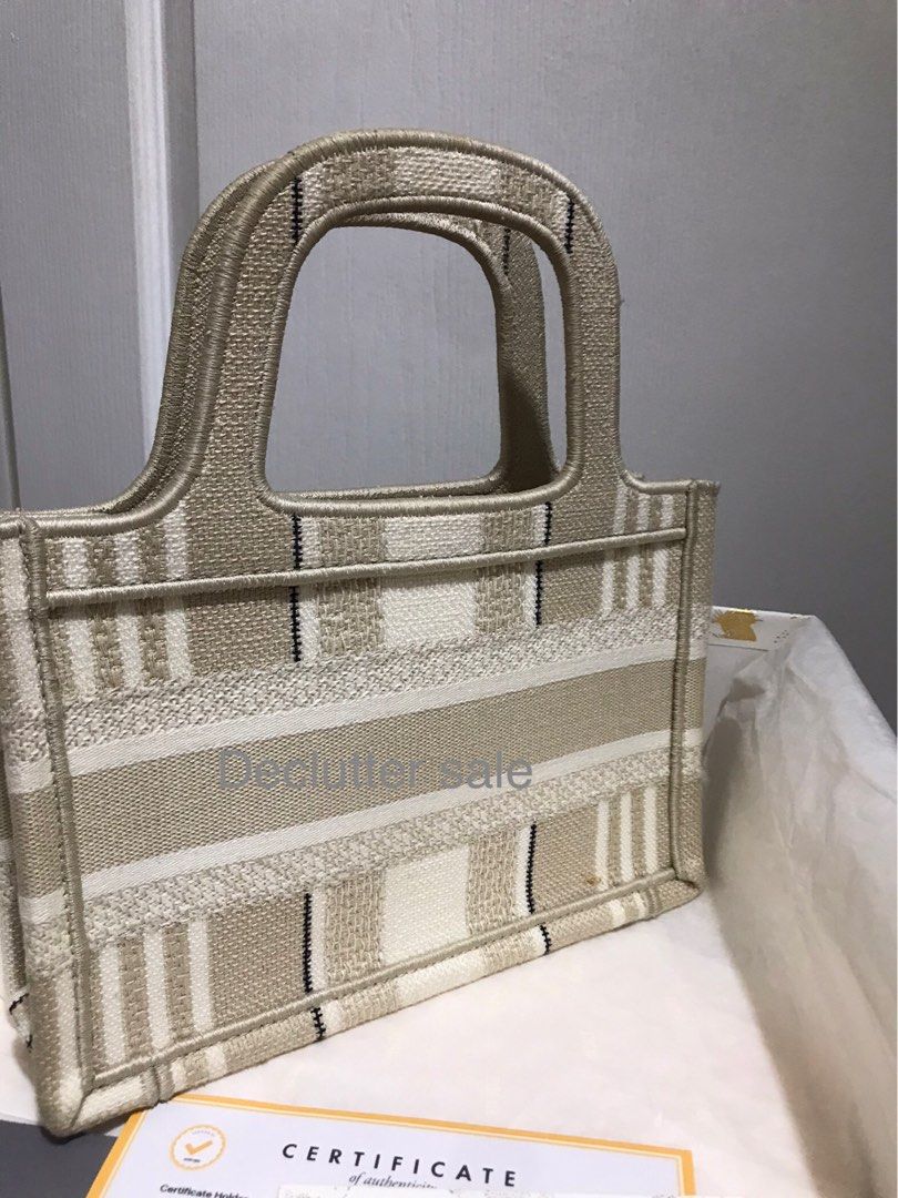 Authentic Dior Book Tote Mini Canvas Authentic with Entrupy certificate (Category: Luxury Bags & Wallets) located in Taguig. Submitted by shop.my.personal.collection (Listing ID 1302264941, Image 3). Description: Dior mini book tote in beige canvas. The cheapest you’ll find in the authentic designer market. Complete with original Dior dust bag, box, paper bag, authenticity card and Entrupy certificate See and buy it here: Mini Book Tote in Beige 