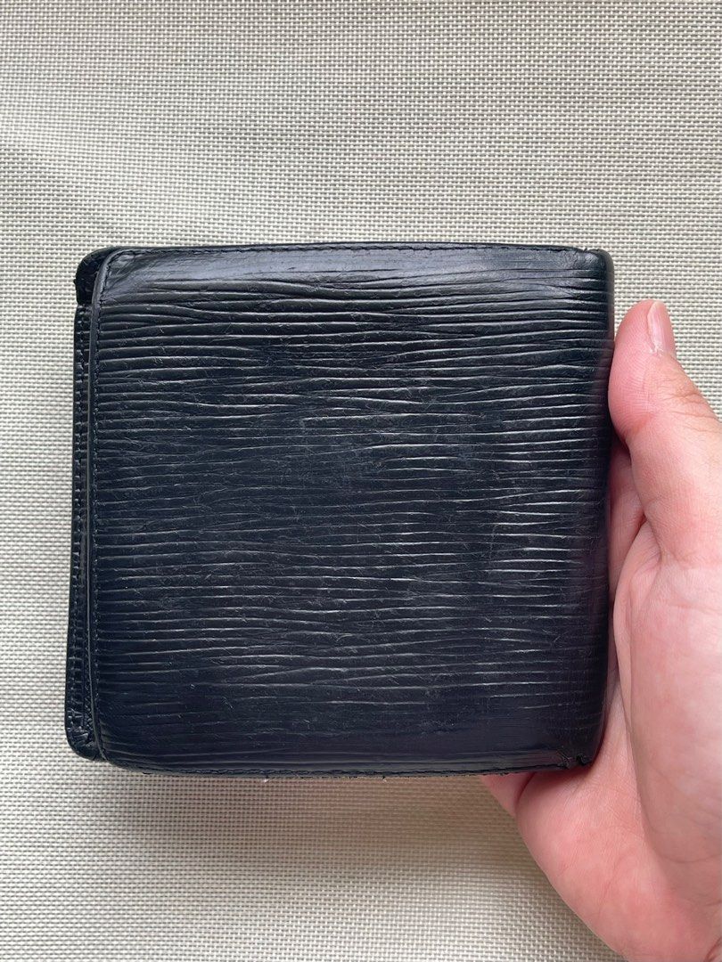 Louis Vuitton Black Epi Bi-Fold Wallet (Category: Wallets & Card Holders) located in Marikina City. Submitted by elle.desmar (Listing ID 1302245144, Image 2). Description: Louis Vuitton Wallet Condition: 8/10 Minor scratches but no peeling inside. Please see photos for details. No inclusions but guaranteed authentic. MOP: Gcash/BPI/Seabank No COD. .