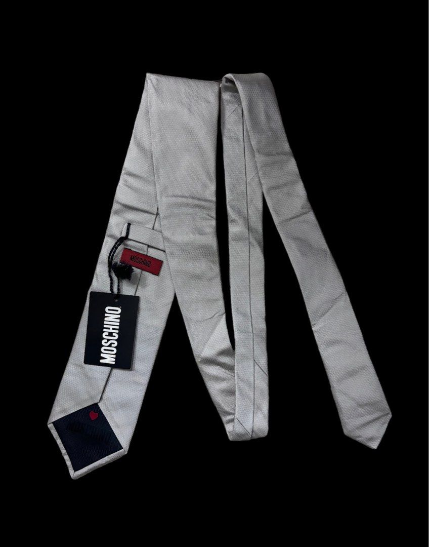 MOSCHINO NECK TIE (Category: Sets & Coordinates) located in Taguig. Submitted by j.gloria (Listing ID 1302282505, Image 1). Description: MOSCHINO GEOMETRICAL LOGO SILK TIE ITALY 59" / 3.7" GRAY IN COLOR BRAND NEW CONDITION WITH TAG.