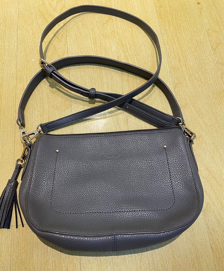 Nicole Miller 2-way Bag (Category: Cross-body Bags) located in Quezon City. Submitted by mariadp9 (Listing ID 1302282560, Image 2). Description: Preloved 2-way bag Leather Material It can be used as shoulder bag and a sling bag, Sling strap is adjustable Comes with 2 straps which are detachable Tassel also detachable Gray in color 1 zipper back pocket 2 open inner pockets and 1 zipper pocket Normal signs of use on the hardwares no major damage Le