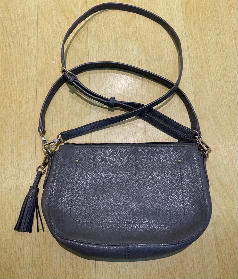 Nicole Miller 2-way Bag (Category: Cross-body Bags) located in Quezon City. Submitted by mariadp9 (Listing ID 1302282560, Image 1). Description: Preloved 2-way bag Leather Material It can be used as shoulder bag and a sling bag, Sling strap is adjustable Comes with 2 straps which are detachable Tassel also detachable Gray in color 1 zipper back pocket 2 open inner pockets and 1 zipper pocket Normal signs of use on the hardwares no major damage Le