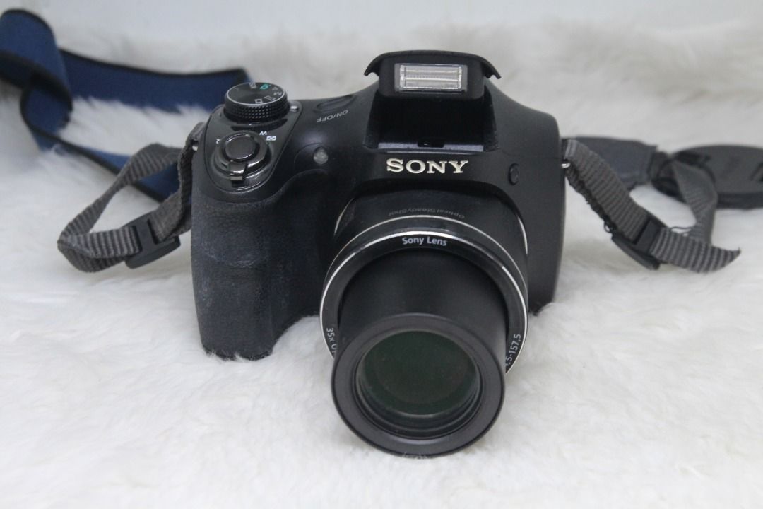 Sony Cyber-shot DSC-H300 20.1 MP CCD sensor Digital Camera (Category: Cameras) located in Manila. Submitted by ultimogizmos (Listing ID 1308340949, Image 1). Description: Sony Cyber-shot DSC-H300 20.1 MP Digital Camera About this item 20.1 megapixel plus 35x zoom brings detailed subjects close - 3.0" LCD screen for easy viewing and photo editing Optical SteadyShot image stabilization reduces blur Capture your videos in 720p HD Movie mode CCD sens