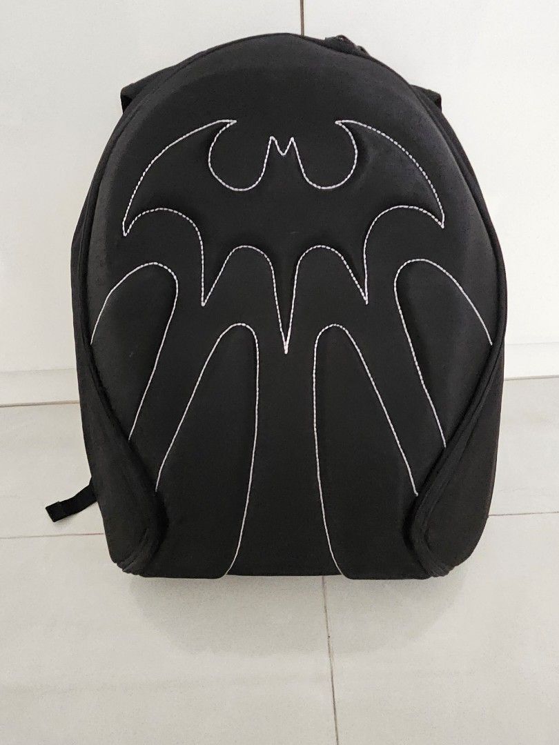 Batman Backpack (Category: Backpacks) located in Singapore. Submitted by silvermoon_411cd9 (Listing ID 1308640803, Image 1). Description: Condition is good. Batman design. Fairly light. Hard cover..