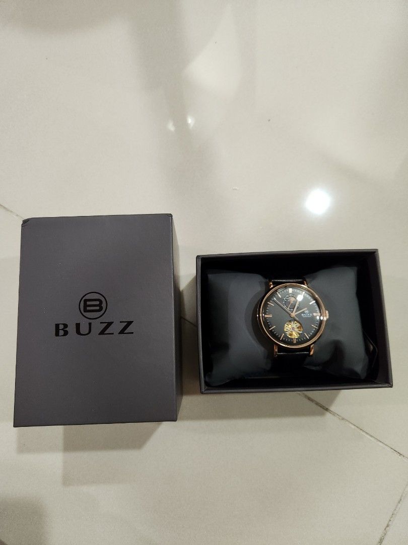 Buzz Germany Automatic Watch (Category: Men's Watches) located in Singapore. Submitted by chngck86 (Listing ID 1308638321, Image 5). Description: *Japan automatic movement *24 hours hand with Sun and Moon display *Open heart design (can see windmil rotating) *Rose gold case with black leather strap *Comes with full box.