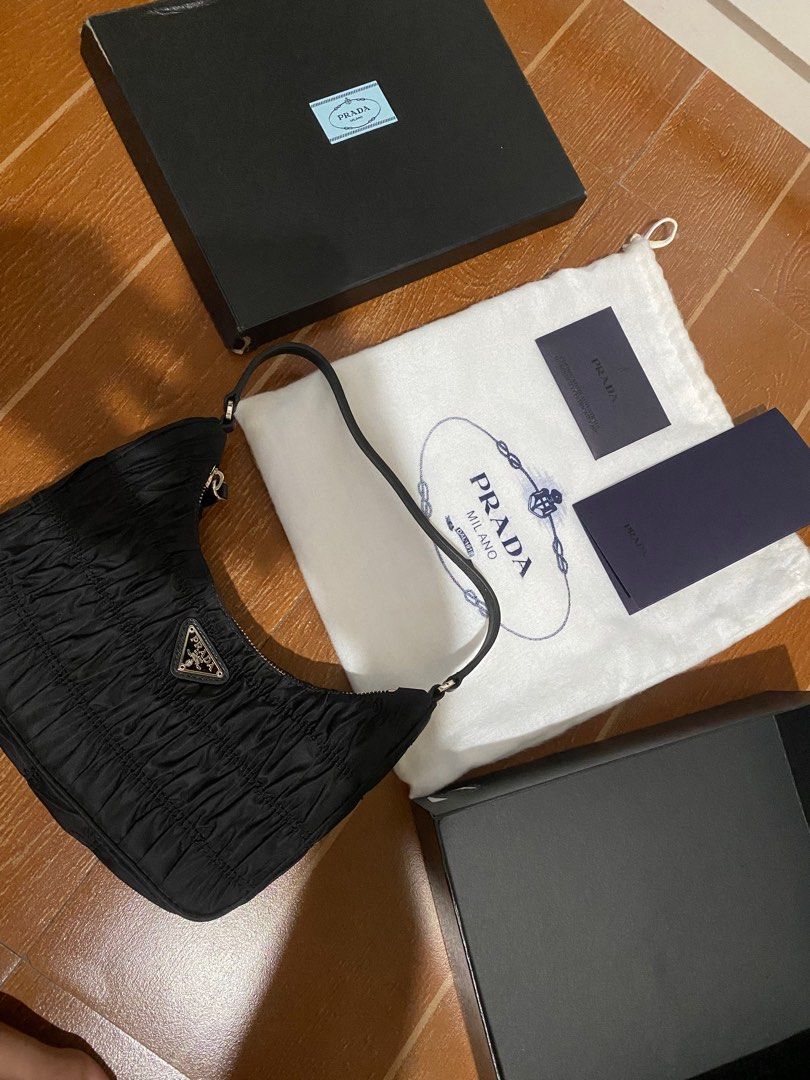 PRADA Tessuto Nylon Gaufre Shoulder Bag Black (Category: Luxury Bags & Wallets) located in Makati City. Submitted by dong4tti (Listing ID 1308578008, Image 1). Description: Complete with box and dustbag, inserts. Size Base length: 8.50 in Height: 4.50 in Width: 2.50 in Drop: 7.50 in This is an authentic PRADA Tessuto Nylon Gaufre Shoulder Bag in Black. This petite Prada handbag is crafted of pleated black tessuto nylon with silver hardware. .
