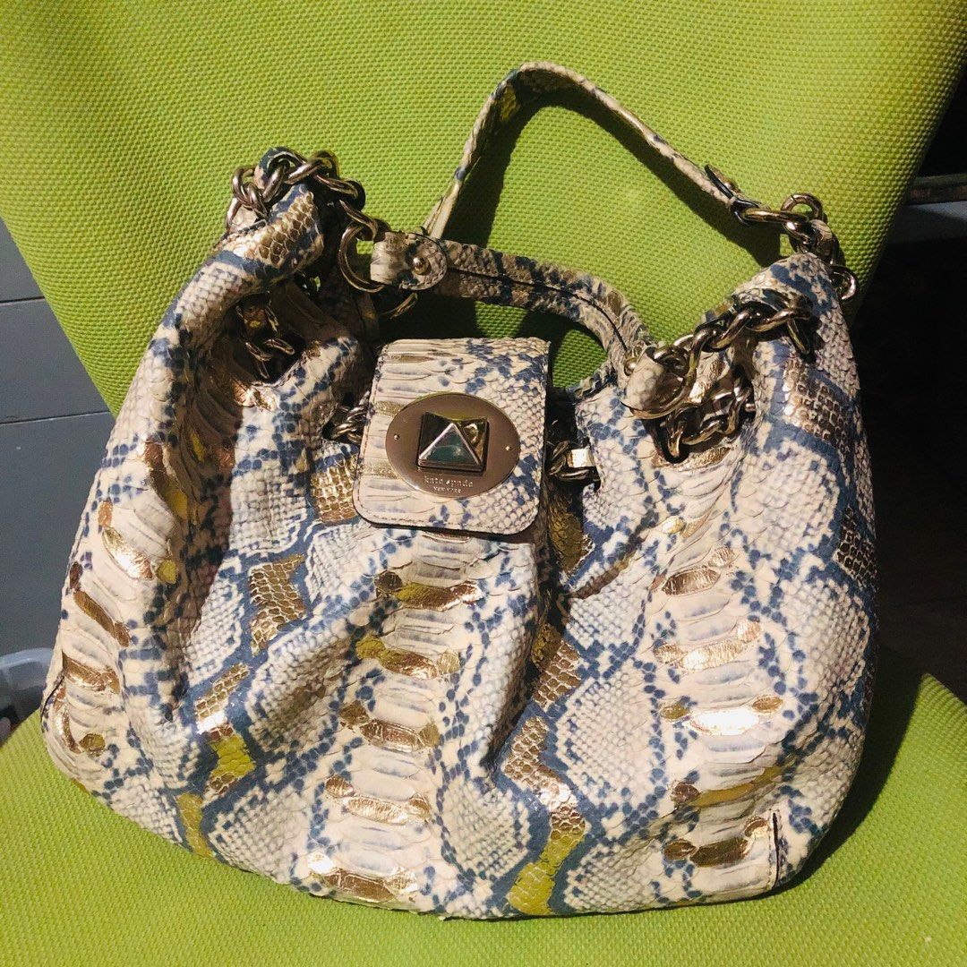 Authentic Kate Spade Bag (Category: Luxury Bags & Wallets) located in Muntinlupa City. Submitted by viaraven (Listing ID 1309118614, Image 1). Description: Kate Spade designer limited edition handbag. Snake embossed on very soft leather, with gold flake detail. Four stud “feet” on bottom to protect handbag and leather straps with chains complete this bucket-style bag. Interior has two slip pockets and one zipper pocket in cream- colored jacquard 
