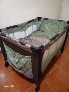 Green and brown crib