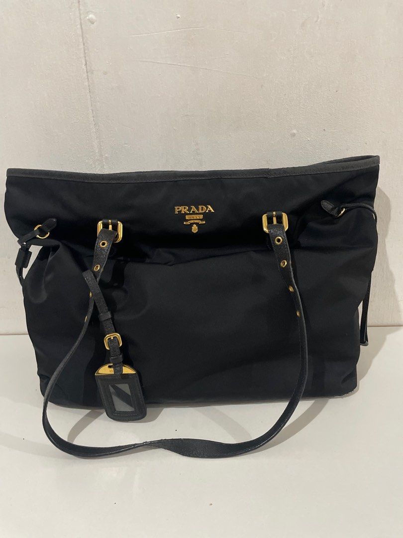 Prada Nylon bag (Store-bought, complete inclusions) (Category: Luxury Bags & Wallets) located in Manila. Submitted by veadeclutters (Listing ID 1309270827, Image 2). Description: Condition: GUC (has some leather cracks, definitely needs cleaning and maybe restoration, hence selling really low 😊) Store-bought in Prada Space Hong Kong in 2018 but barely used since 2020 (because of the pandemic). Inclusions: paper bag, dustbag, care card, authentic