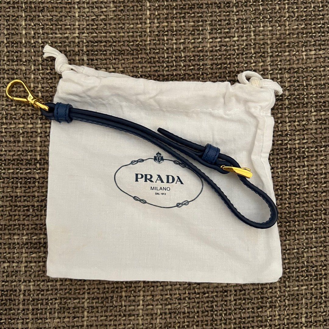 Prada wristlet or celphone holder (Category: Luxury Bags & Wallets) located in Antipolo. Submitted by starstyleph (Listing ID 1309231974, Image 2). Description: Can be used as wristlet, key chain, or celphone holder Made of saffiano leather in gold hardware.