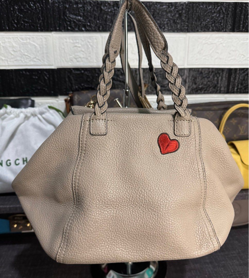 Tory Burch 2way Shoulder Bag Half Moon (Category: Luxury Bags & Wallets) located in Dagupan City. Submitted by luckyluxbyemgee (Listing ID 1309316786, Image 2). Description: Authentic Tory Burch 💯‼️ Moneyback if proven fake The Peace Embellished Half-Moon Small Satchel Pebbled leather * Double zipper closure * Flat handles with braided detailing; 4.98" (12.5 cm) drop * Adjustable, removable cross-body strap with 23.3" (58.5 cm) drop * 1 exterior