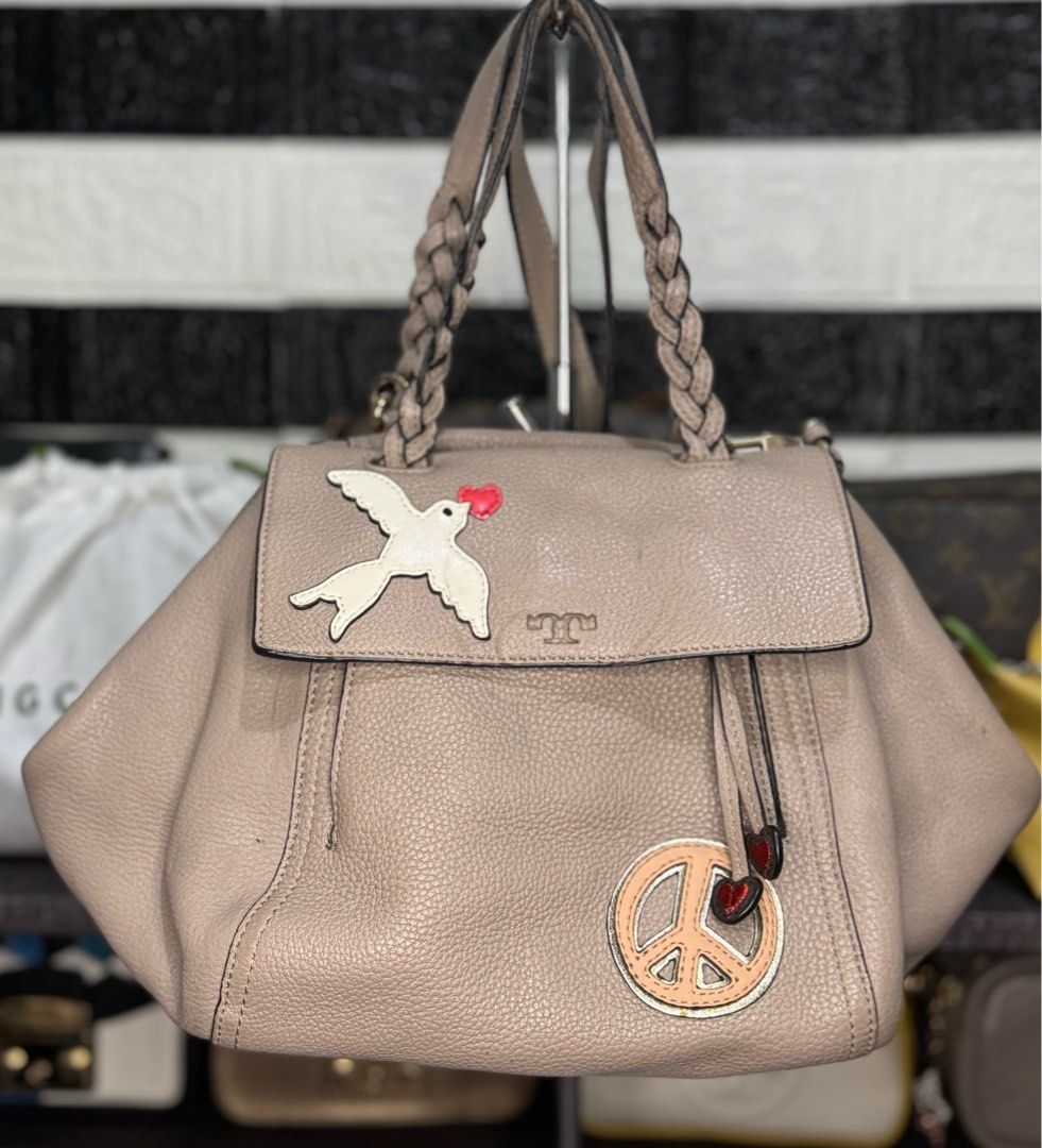 Tory Burch 2way Shoulder Bag Half Moon (Category: Luxury Bags & Wallets) located in Dagupan City. Submitted by luckyluxbyemgee (Listing ID 1309316786, Image 1). Description: Authentic Tory Burch 💯‼️ Moneyback if proven fake The Peace Embellished Half-Moon Small Satchel Pebbled leather * Double zipper closure * Flat handles with braided detailing; 4.98" (12.5 cm) drop * Adjustable, removable cross-body strap with 23.3" (58.5 cm) drop * 1 exterior
