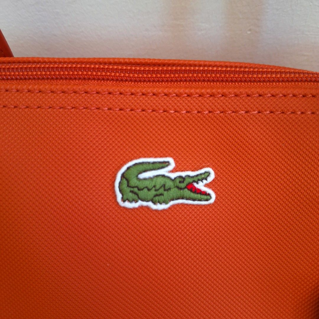 Lacoste Cow Leather Shopping Bag (Category: Luxury Bags & Wallets) located in San Pedro. Submitted by graceleen00 (Listing ID 1309381694, Image 3). Description: Introducing this Red Shopping Bag from Lacoste, crafted with precision and luxury in mind. Elevate your style effortlessly. Features: ○ Small Separate Compartment inside ○ Spacious Interior ○ Zipper Closure ○ 100% Authentic ○ Elegant Design ○ Made of Cow Leather ○ Perfect for Everyday Use