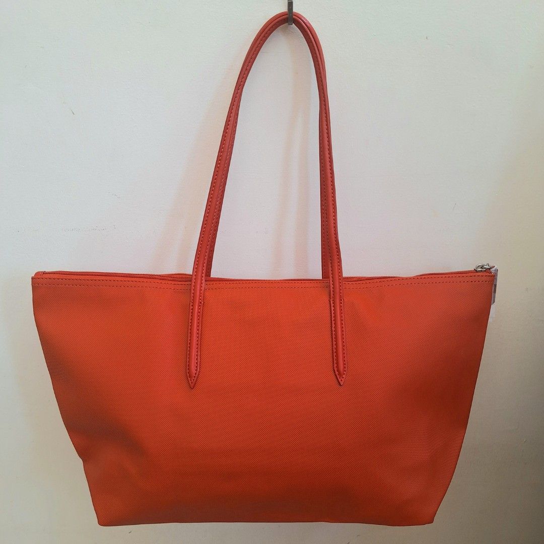 Lacoste Cow Leather Shopping Bag (Category: Luxury Bags & Wallets) located in San Pedro. Submitted by graceleen00 (Listing ID 1309381694, Image 2). Description: Introducing this Red Shopping Bag from Lacoste, crafted with precision and luxury in mind. Elevate your style effortlessly. Features: ○ Small Separate Compartment inside ○ Spacious Interior ○ Zipper Closure ○ 100% Authentic ○ Elegant Design ○ Made of Cow Leather ○ Perfect for Everyday Use