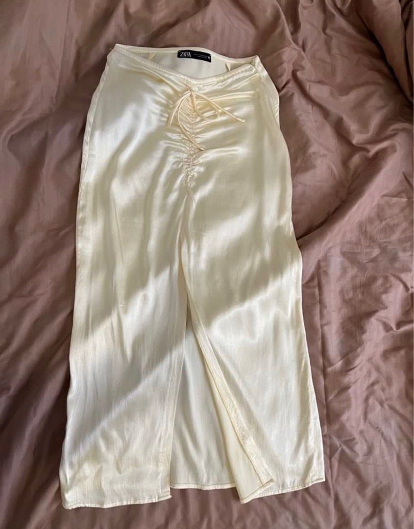 ZARA Yellow Satin Skirt (Category: Skirts) located in Pasig City. Submitted by kvdecluttering (Listing ID 1309567439, Image 1). Description: ZARA SATIN SKIRT YELLOW With front slit Has side zipper Size XS (fits W24-25) Length 33in Used 1x Sf P80 within metro mnl.