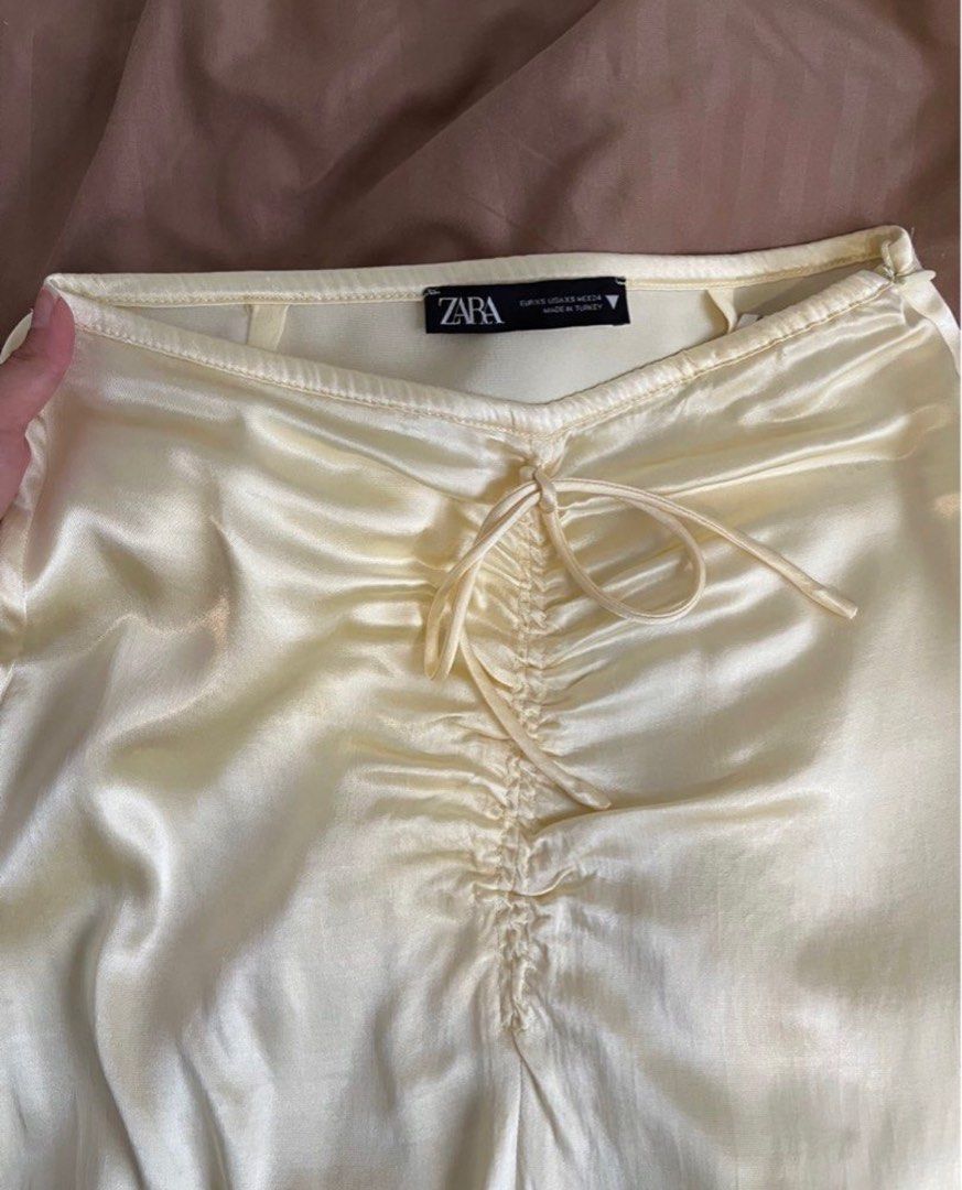 ZARA Yellow Satin Skirt (Category: Skirts) located in Pasig City. Submitted by kvdecluttering (Listing ID 1309567439, Image 2). Description: ZARA SATIN SKIRT YELLOW With front slit Has side zipper Size XS (fits W24-25) Length 33in Used 1x Sf P80 within metro mnl.