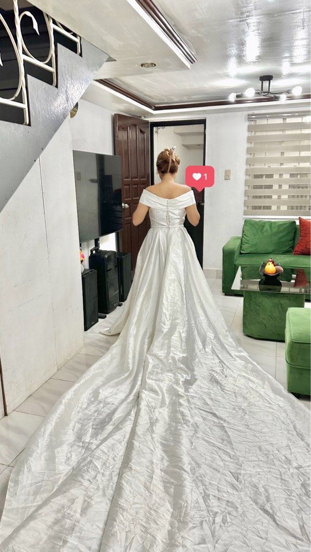 Minimalist Wedding gown (Category: Evening dresses & gowns) located in Quezon City. Submitted by nelle_13 (Listing ID 1306669694, Image 2). Description: Selling my minimalist wedding gown super long trail Small-Medium frame (fits waist of 26-28) No issues Complete lahat butones (pearl ang butones sa likod) Need wash lang Makapal ang tela PS: bought this wedding gown in Thailand.