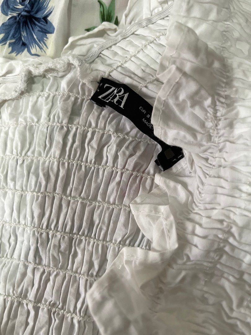 Zara white smoked off shoulder top (Category: Blouses) located in Manila. Submitted by deardeclutter (Listing ID 1309966098, Image 3). Description: Need stitching on underarm part but not too noticeable .